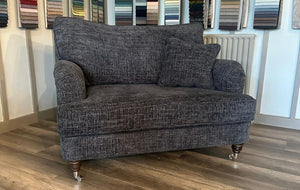 Gray sofa in a room with color swatches on the wall