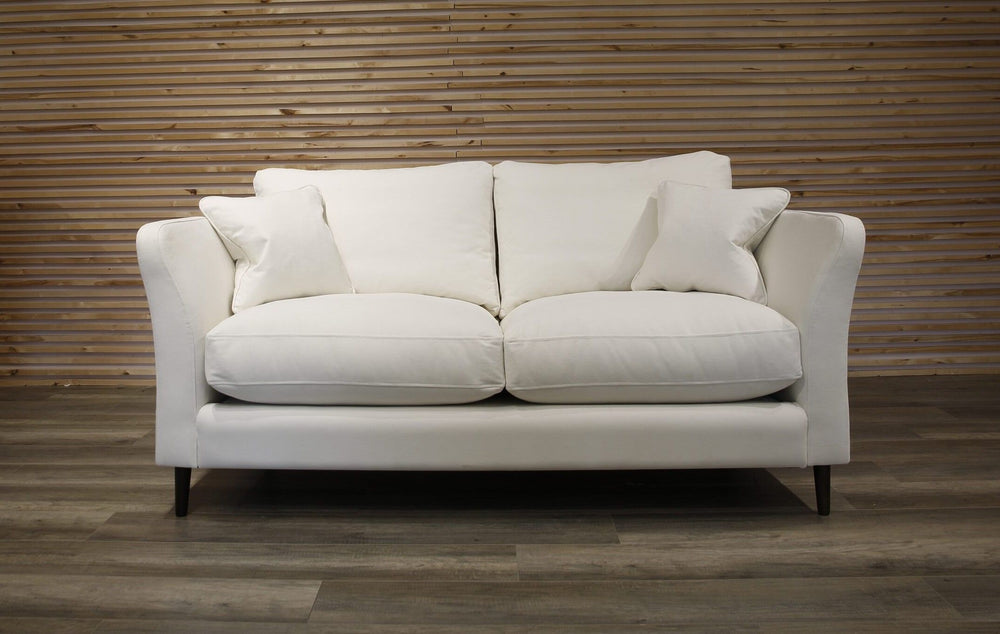 White sofa against a wooden paneled wall